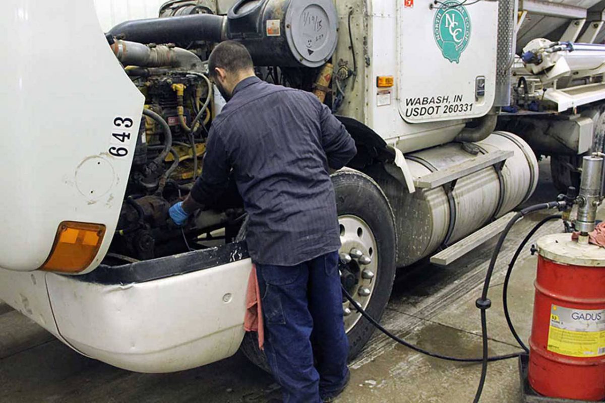 mechanic completing preventative truck maintenance